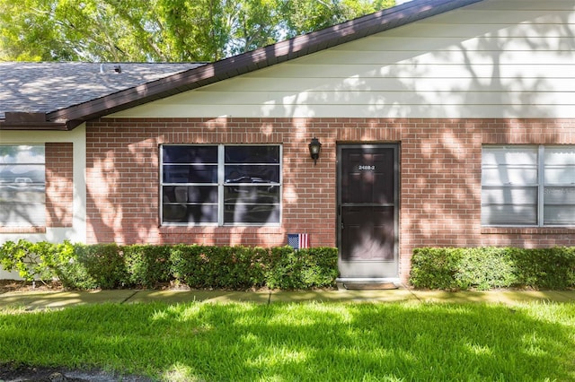 doorway to property featuring a yard