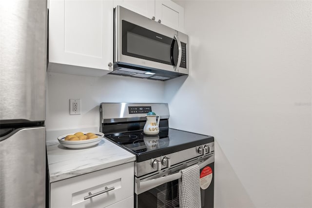 kitchen with white cabinetry and stainless steel appliances