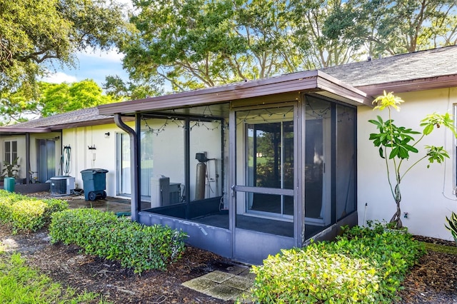 doorway to property featuring central air condition unit