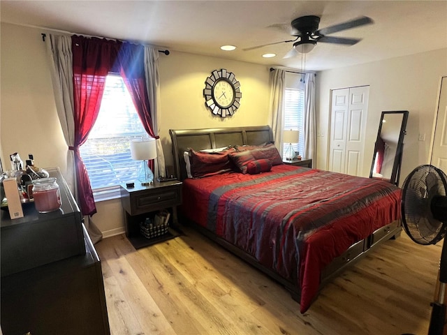 bedroom featuring ceiling fan, a closet, and light hardwood / wood-style flooring