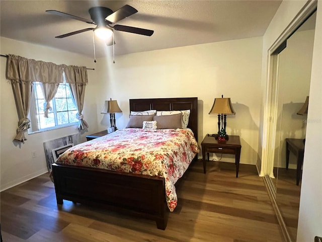 bedroom featuring ceiling fan and dark hardwood / wood-style flooring