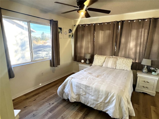 bedroom with ceiling fan and dark hardwood / wood-style flooring