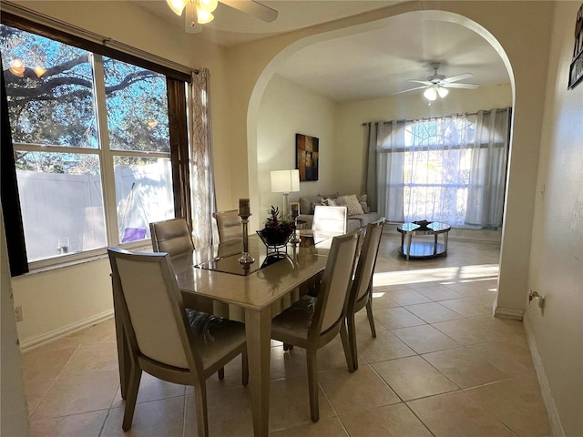 tiled dining area featuring ceiling fan