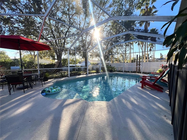 view of pool featuring a patio and glass enclosure