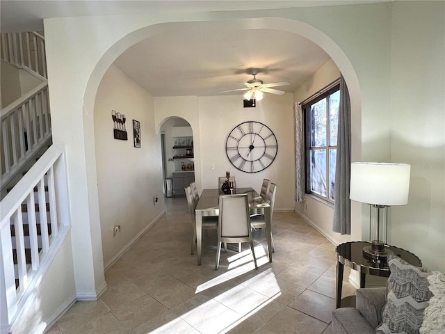 dining space featuring ceiling fan and light tile patterned flooring