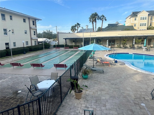 community pool with shuffleboard and fence