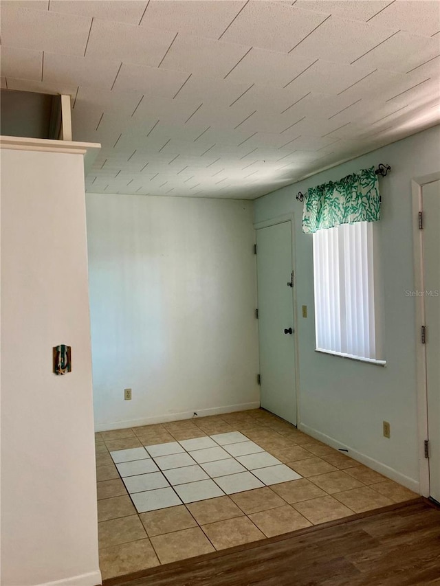 empty room with light wood finished floors and baseboards