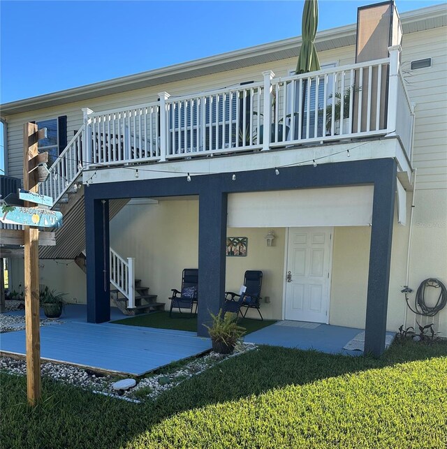 back of house with a patio area, a deck, and a yard