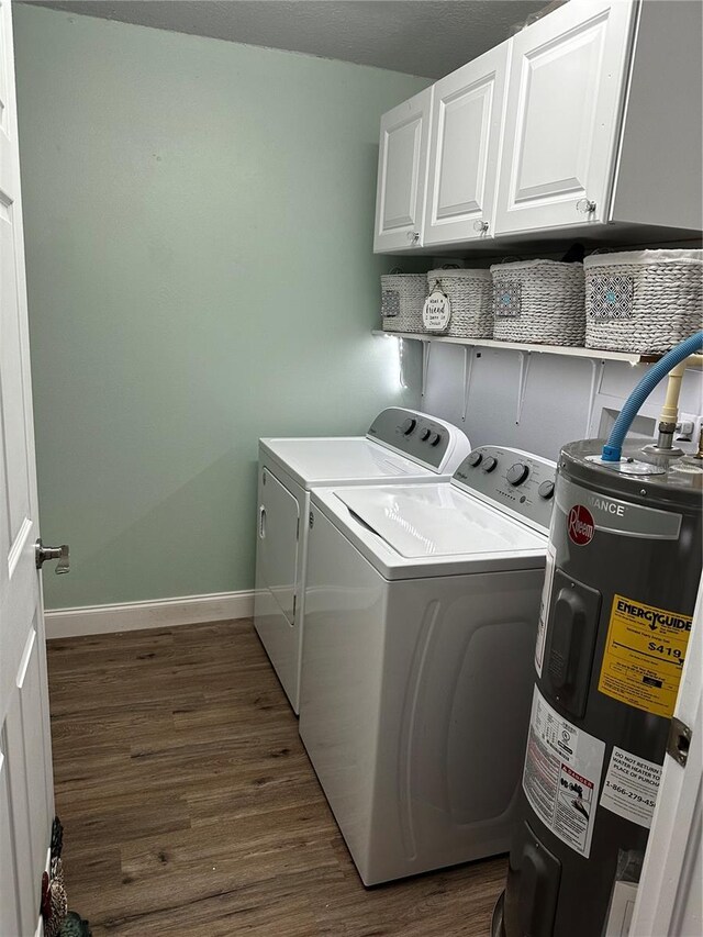 laundry room with cabinets, washer and clothes dryer, dark hardwood / wood-style flooring, and water heater