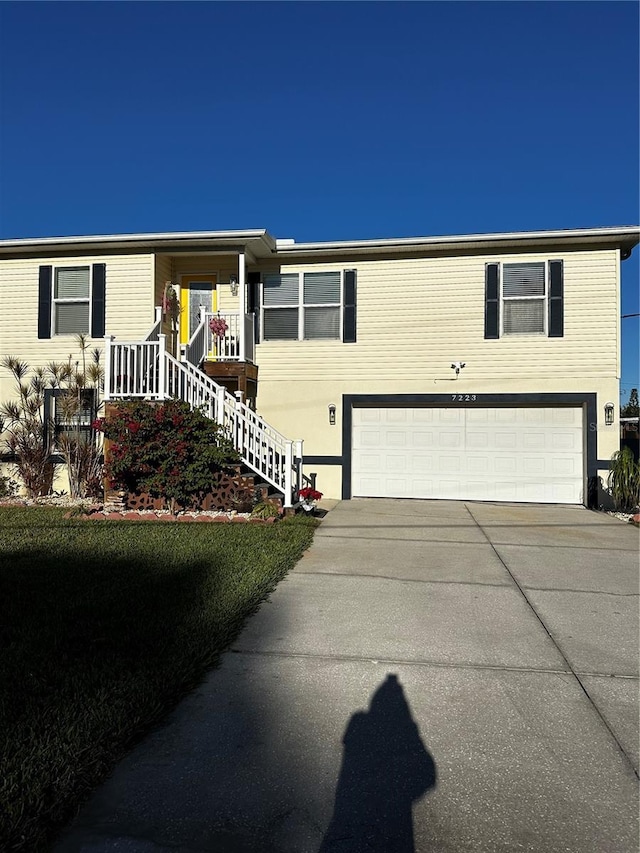 view of front of house featuring covered porch and a garage