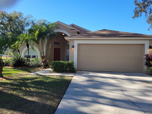 view of front of house with a garage and a front lawn