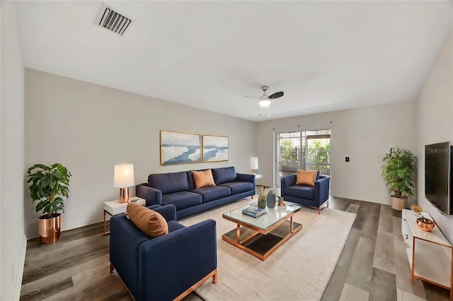 living room featuring hardwood / wood-style flooring and ceiling fan