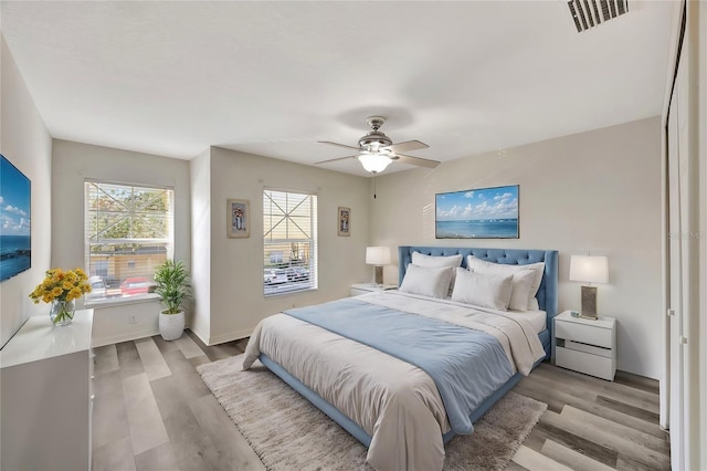 bedroom featuring light hardwood / wood-style floors and ceiling fan