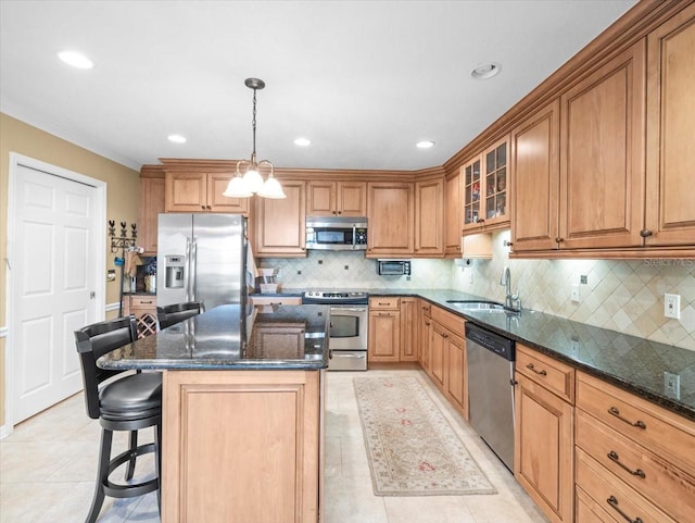 kitchen featuring pendant lighting, a center island, sink, tasteful backsplash, and stainless steel appliances