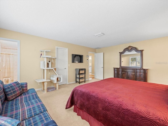 carpeted bedroom with a textured ceiling