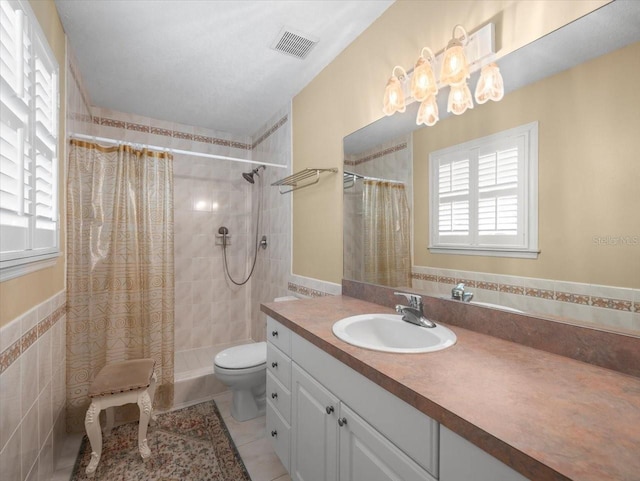 bathroom featuring tile patterned floors, vanity, a shower with shower curtain, and toilet