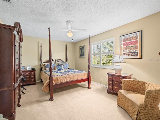 bedroom with light carpet, a textured ceiling, and ceiling fan