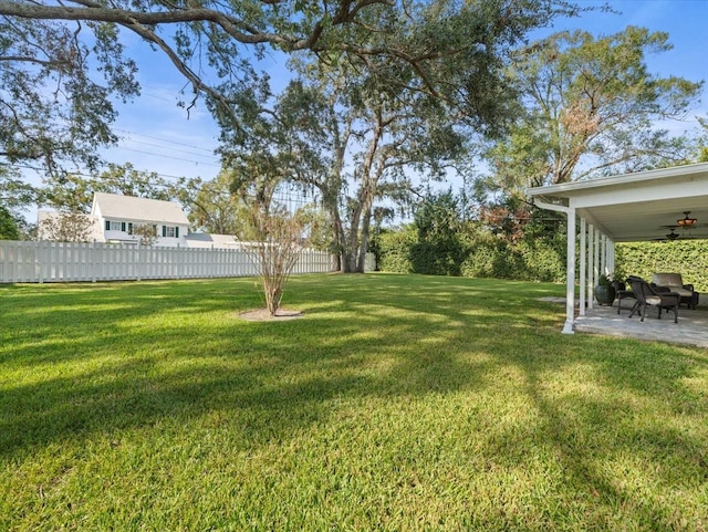 view of yard featuring a patio area and ceiling fan