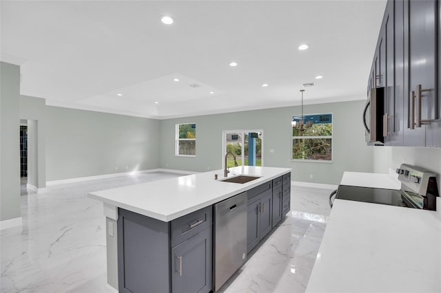 kitchen featuring a kitchen island with sink, hanging light fixtures, sink, gray cabinets, and stainless steel appliances