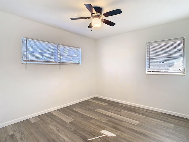 spare room with a ceiling fan, baseboards, and wood finished floors