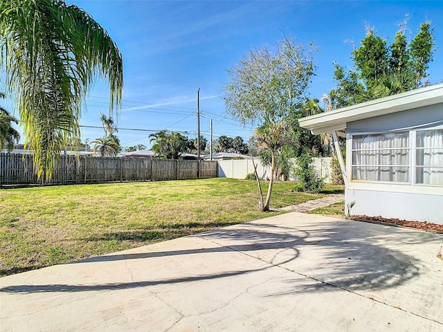 view of yard featuring a patio area and a fenced backyard