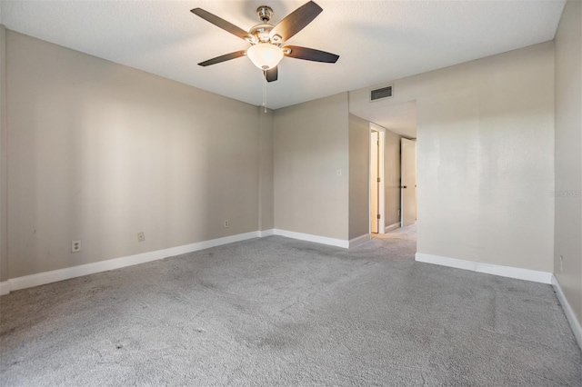 carpeted empty room featuring ceiling fan and a textured ceiling