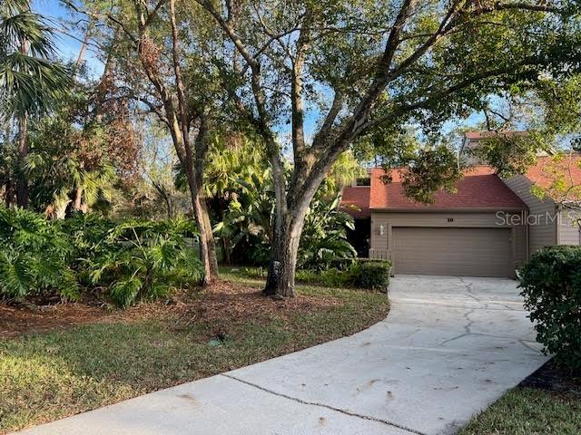 10 Woodridge Cir, Oldsmar, FL 34677 - view of front facade featuring concrete driveway and an attached garage