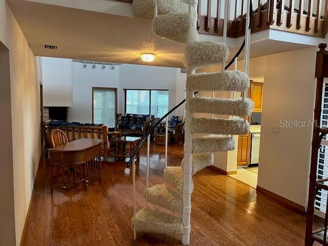 interior space with hardwood / wood-style floors and a high ceiling