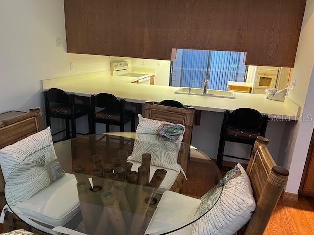 dining space featuring light wood-type flooring and sink