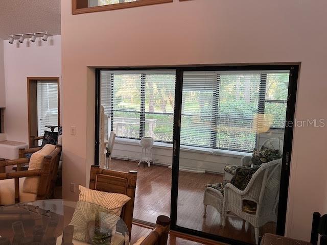 doorway to outside featuring plenty of natural light and track lighting