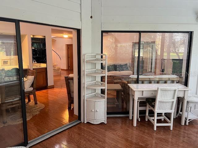 interior space with wood walls, hardwood / wood-style floors, and a healthy amount of sunlight