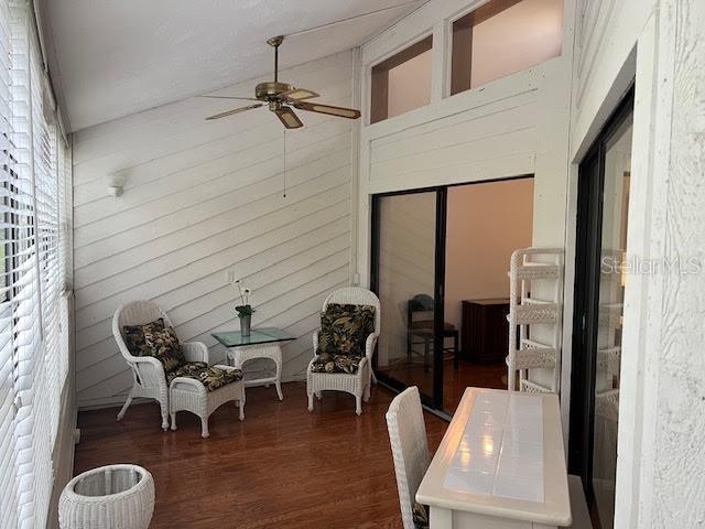 sunroom with ceiling fan and lofted ceiling