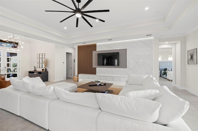 tiled living room with french doors, ornamental molding, a notable chandelier, and a tray ceiling