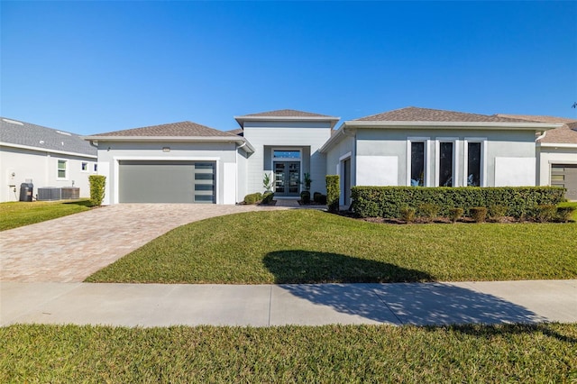 view of front of property with a garage and a front lawn