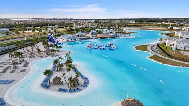 drone / aerial view with a beach view and a water view