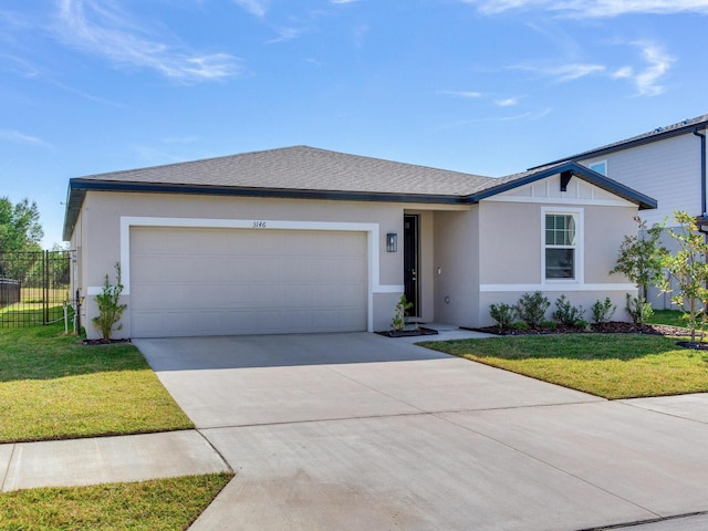 single story home featuring a garage and a front lawn