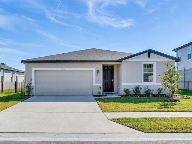 view of front of house with a garage and a front yard