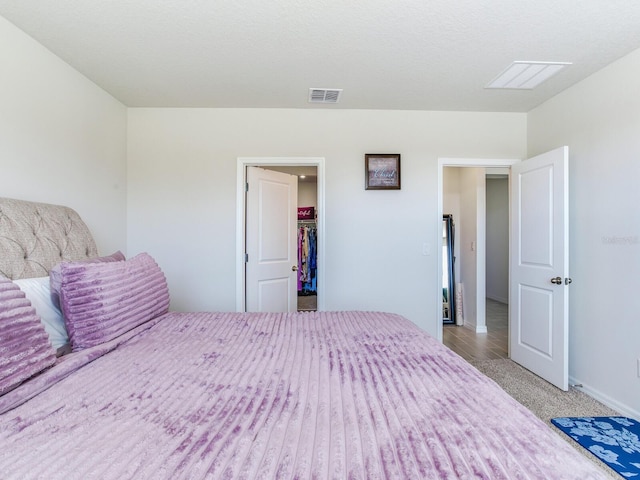 unfurnished bedroom featuring a walk in closet