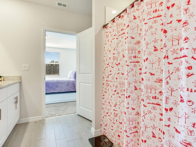 bathroom with a shower with shower curtain and vanity