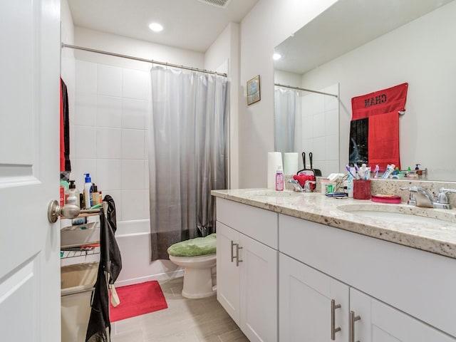 full bathroom featuring toilet, vanity, and shower / bath combination with curtain