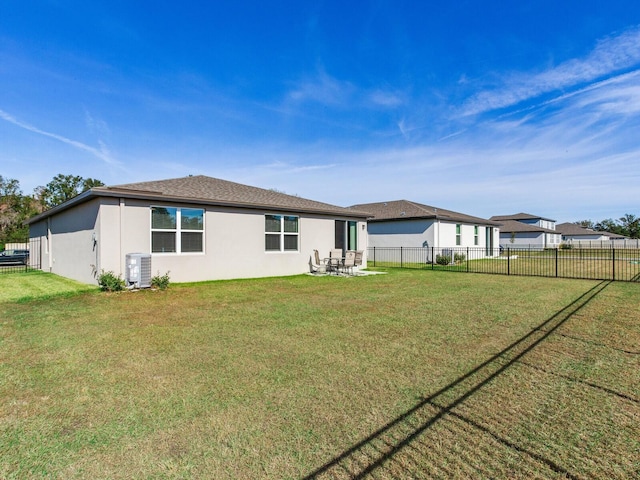 rear view of property with a yard and cooling unit