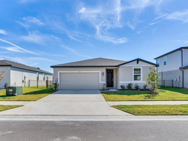 view of front of property featuring a front yard and a garage