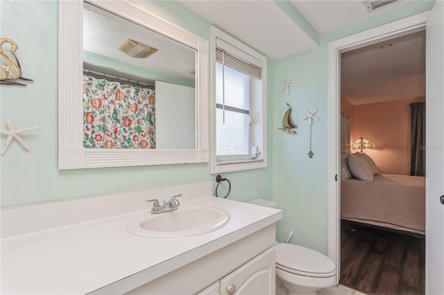 bathroom featuring hardwood / wood-style floors, toilet, and vanity