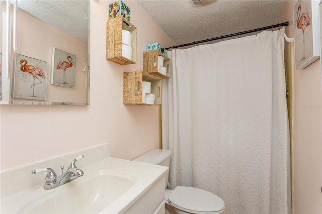 bathroom with toilet, vanity, a textured ceiling, and curtained shower