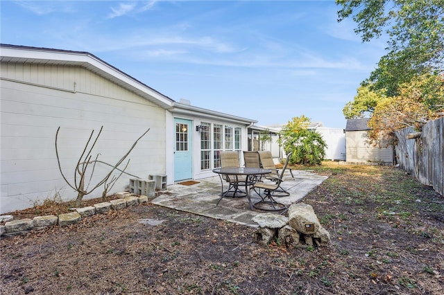 view of yard featuring a storage unit and a patio area