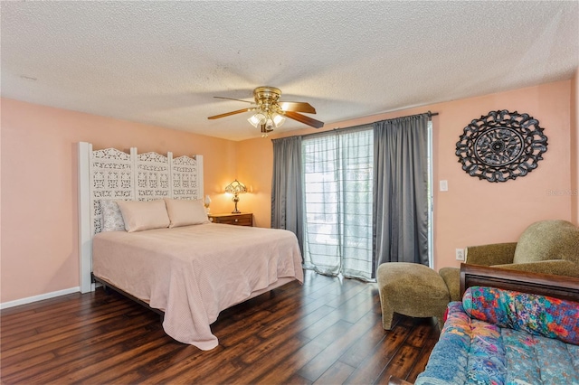 bedroom with ceiling fan, a textured ceiling, and dark hardwood / wood-style flooring