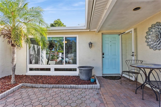 entrance to property featuring a patio area