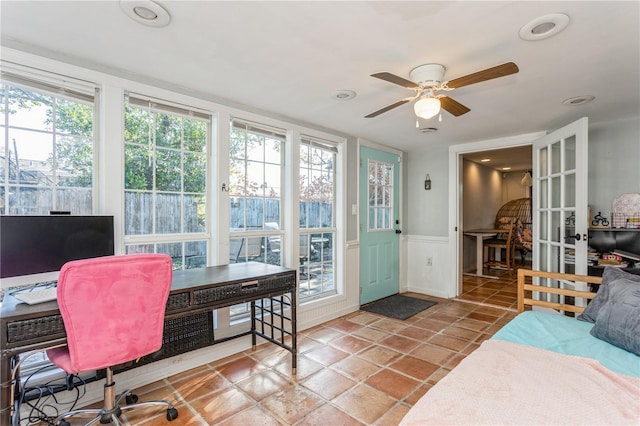 interior space with ceiling fan