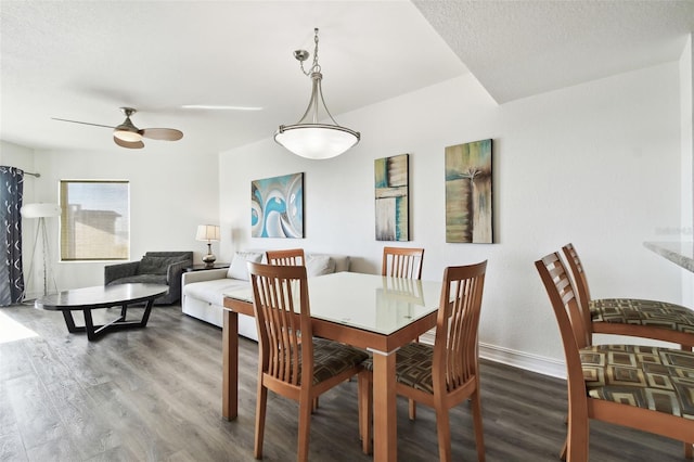 dining space with wood-type flooring, a textured ceiling, and ceiling fan