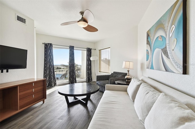 living room with ceiling fan and wood-type flooring